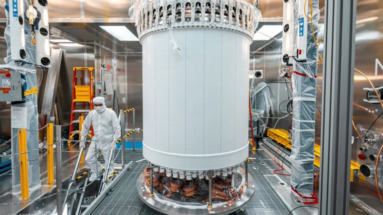 The LUX-ZEPLIN main dark matter detector, a large cylindrical tank, pictured in a surface lab before its installation nearly a mile underground at the Sanford Underground Research Facility